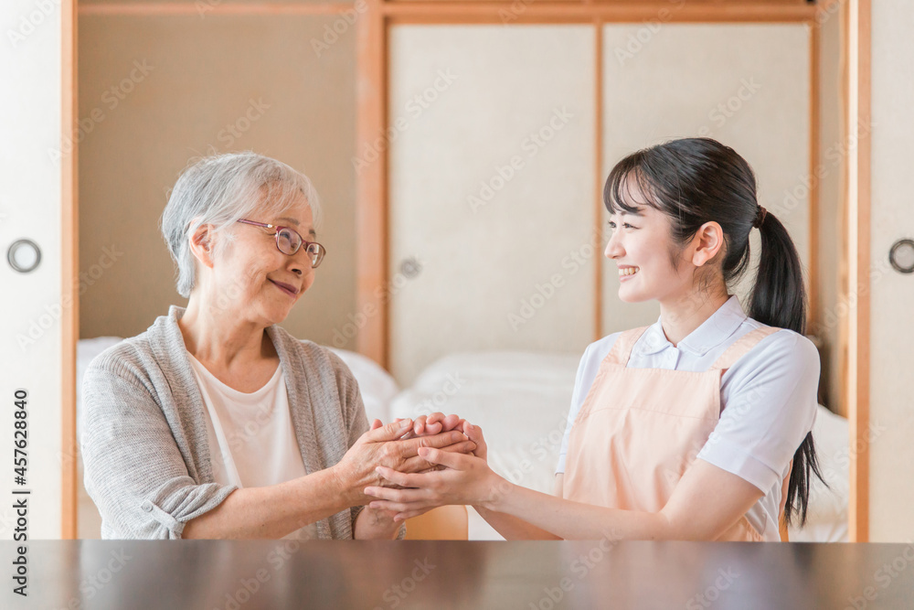 高齢者女性と話す女性スタッフ
