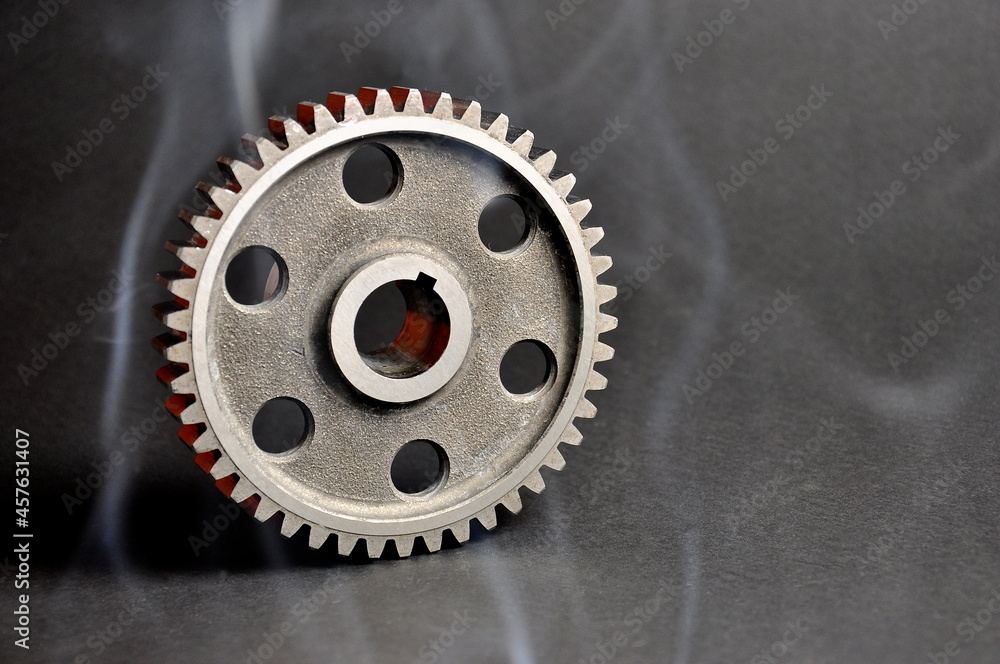 Engine parts. Pinion on a dark background. Spare parts. Engine parts. Pinion on a dark background. Spare parts.