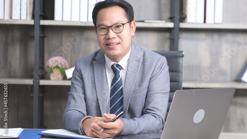 Portrait of senior asian businessman smiling and looking at camera while sitting at office  Executive CEO  asia man  in formal suit at workplace  People occupation