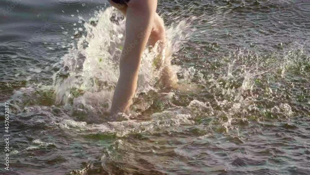 Barefoot kids legs feet running on sand beach ocean shore at sunset. Summer vacation, holiday, family trip. Tourism to warm countries. Barefoot kids legs feet running on sand beach ocean shore at sunset. Summer vacation, holiday, family trip. Tourism to warm countries.