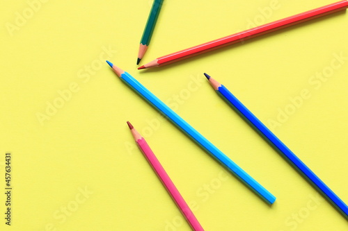 Colored pencils on a colored background. A set of pencils for drawing. Background from pencils. © Nadya Kolobova