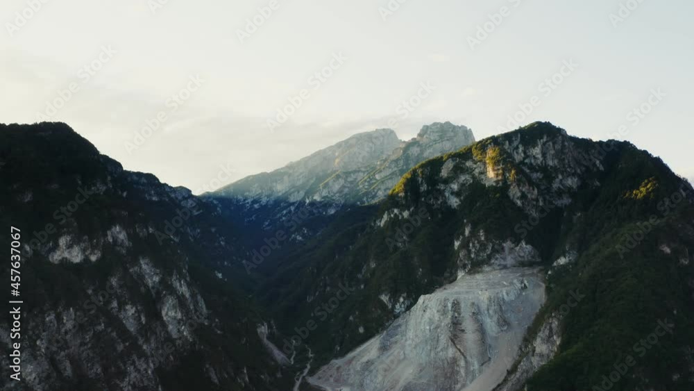 The rocky peaks of the mountains are covered with the sun light from quadcopter The rocky peaks of the mountains are covered with the sun light from quadcopter