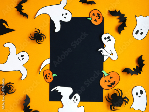 Halloween. Background for stocks and foyers. Allocated space for text. The ghost points to your text. Pumpkin, bat, witch hat, spider, black, orange.