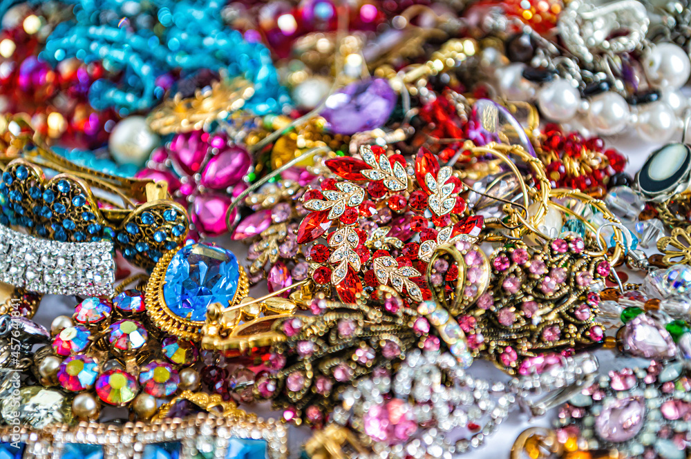 necklaces, earrings, bracelets, pearls, beads and various colored gemstones as a background necklaces, earrings, bracelets, pearls, beads and various colored gemstones as a background