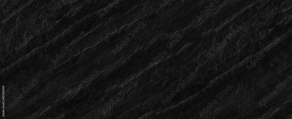 Fototapeta premium Panorama dark gray stone background with copy space. Black grunge banner with rock texture.