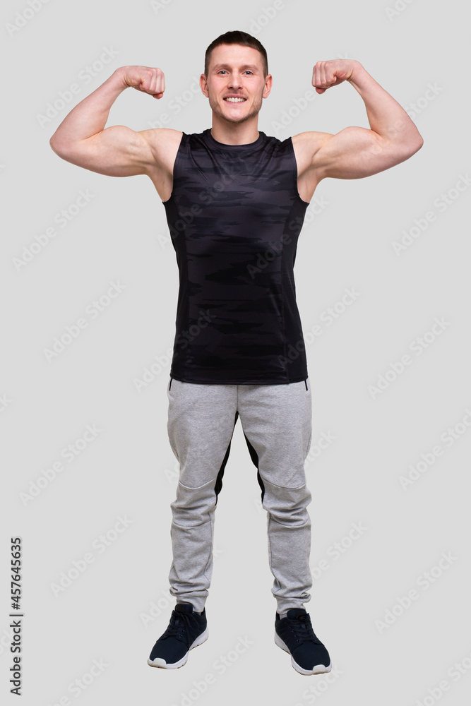 Man Showing Biceps Hands Up. Sportsman Showing Muscles. ABS, Biceps Muscles. Man Standing Isolated Man Showing Biceps Hands Up. Sportsman Showing Muscles. ABS, Biceps Muscles. Man Standing Isolated
