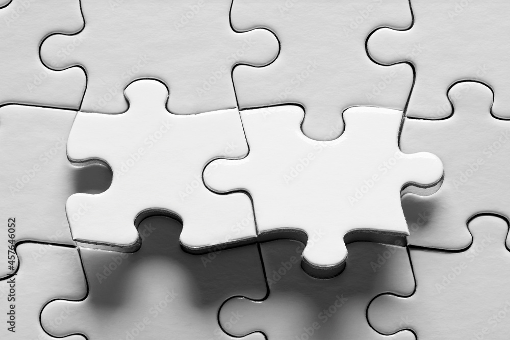 Jigsaw puzzle with two connected pieces are about be placed. Puzzle game, solution, connection Jigsaw puzzle with two connected pieces are about be placed. Puzzle game, solution, connection