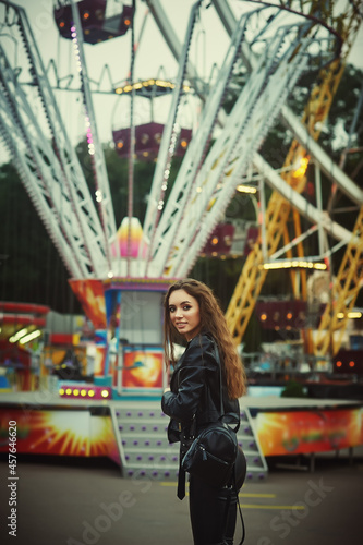 Young attractive girl in an evening amusement park