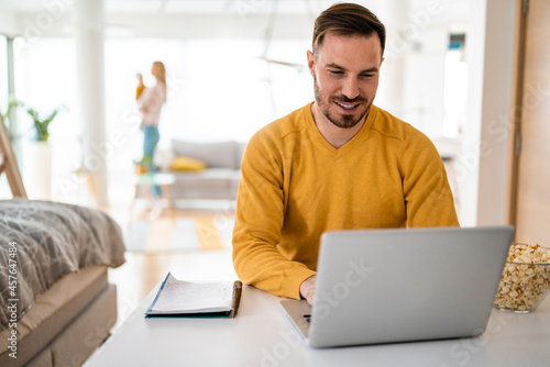 Handsome man designer working home using laptop at home