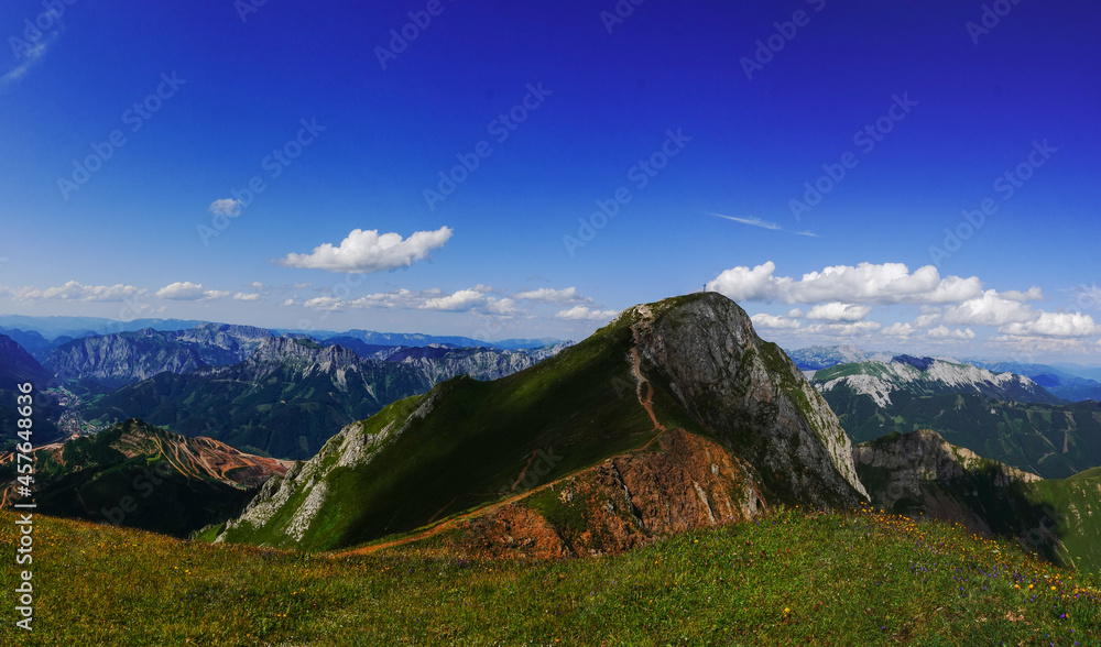 steep mountain with a summit cross and amazing mountain landscape panorama steep mountain with a summit cross and amazing mountain landscape panorama