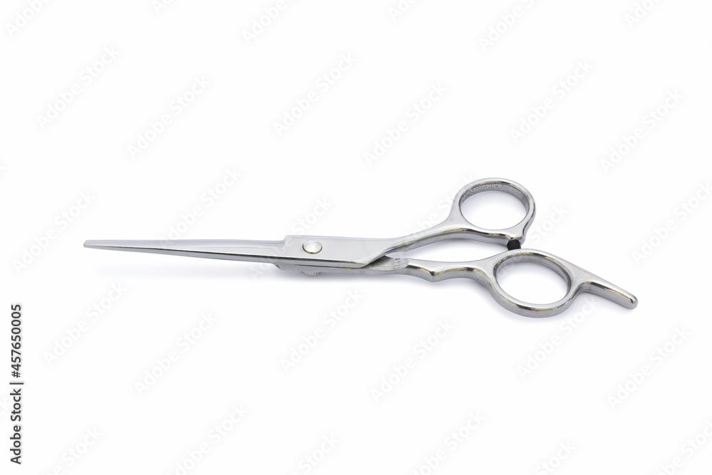 A silver hair cutting scissors with isolated on white background. A silver hair cutting scissors with isolated on white background.