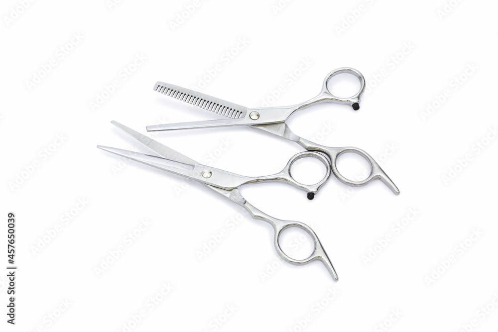 Two pairs of silver hairdressing scissors for hair cutting with isolated on white background. Two pairs of silver hairdressing scissors for hair cutting with isolated on white background.