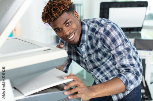 young man operating a copy machine