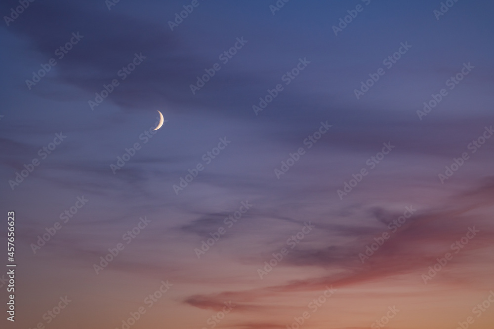 A bright month against a blue-violet sky. Night landscape. Moon. Mysterious mystical evening. A bright month against a blue-violet sky. Night landscape. Moon. Mysterious mystical evening.