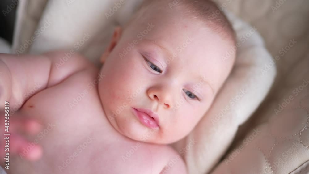 Cute newborn baby boy sitting in a white high chair next to a window. A joyful lifestyle of a happy mixed-race family. A young asian woman and active healthy baby with blue eyes in a rabbit costume Cute newborn baby boy sitting in a white high chair next to a window. A joyful lifestyle of a happy mixed-race family. A young asian woman and active healthy baby with blue eyes in a rabbit costume