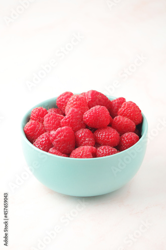 A bowl with ripe bright raspberries	