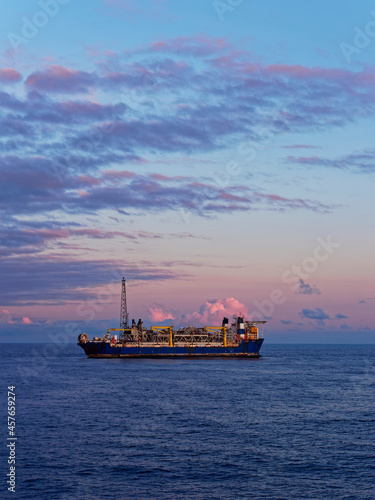 The Alvheim FPSO situated in the Norwegian North Sea attached to its Turret and undergoing maintenance Operations at Dawn.