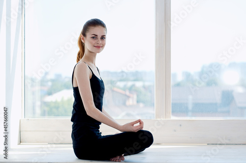 Free Download woman in sports uniform near the window fitness exercise meditation - GFXLoad