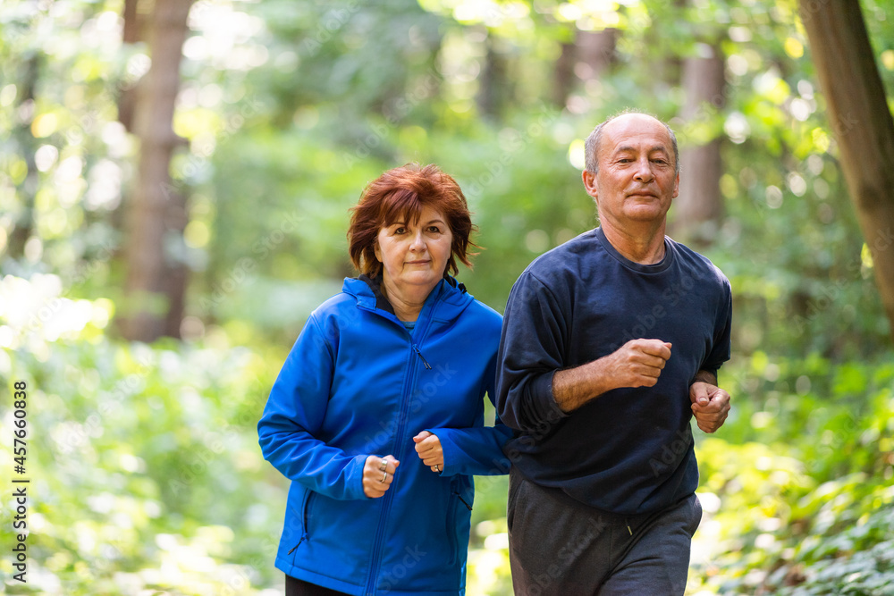 Happy senior couple running together