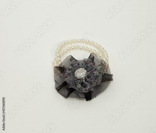 Women's bracelet with hand stones. with white stones and black bow. Feminine decoration. On an isolated white background