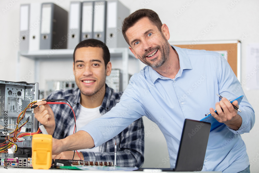 supervisor with male apprentice computer technician
