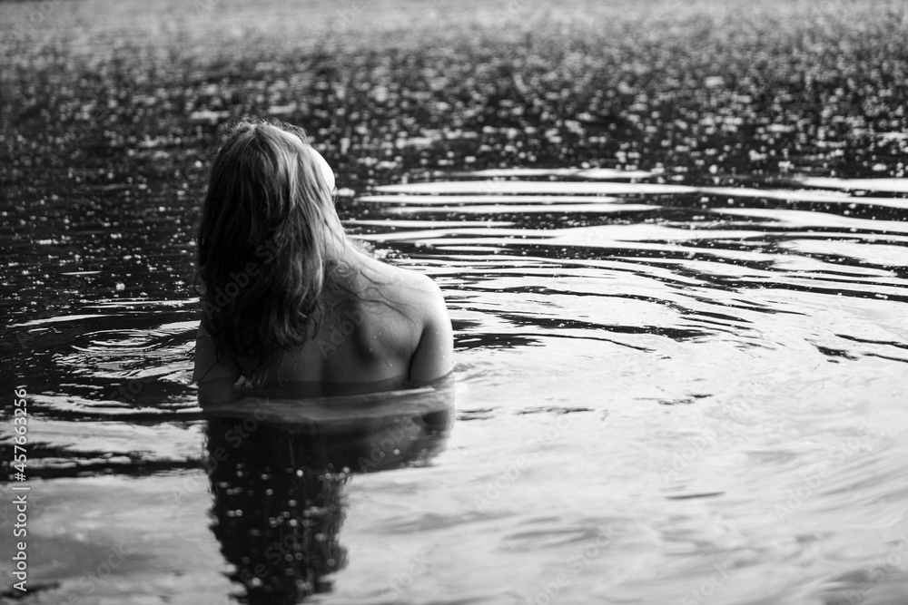 Fototapeta premium Caucasian woman in water. Monochrome