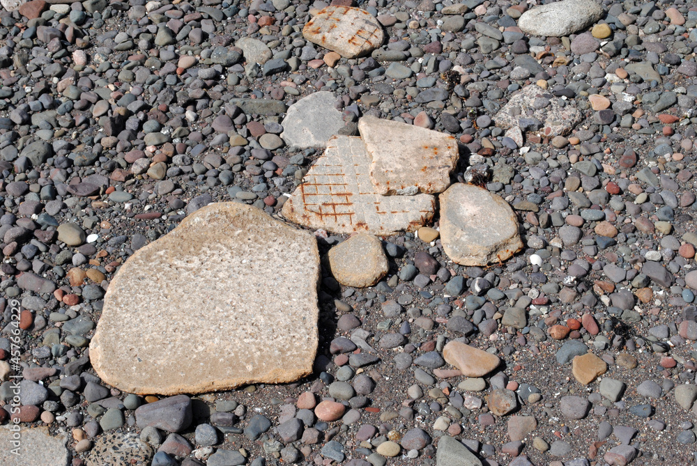 Close Up of Textured Broken Rocks & Concrete on Shingle Beach Close Up of Textured Broken Rocks & Concrete on Shingle Beach