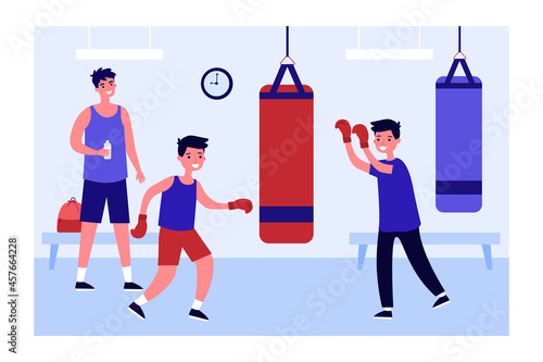 Coach or father watching sons hitting punching bag in gym. Boys in boxing gloves training together flat vector illustration. Sports, family, healthy lifestyle concept for banner, website design