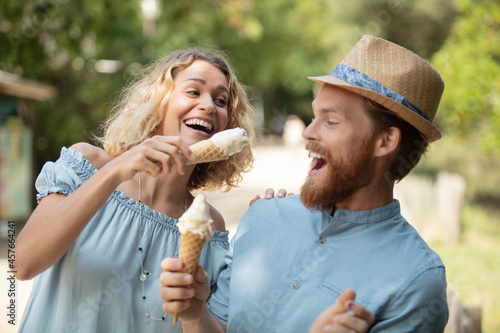 happy couple having date and eating ice cream