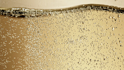 Close-up of champagne bubbles background with foam.