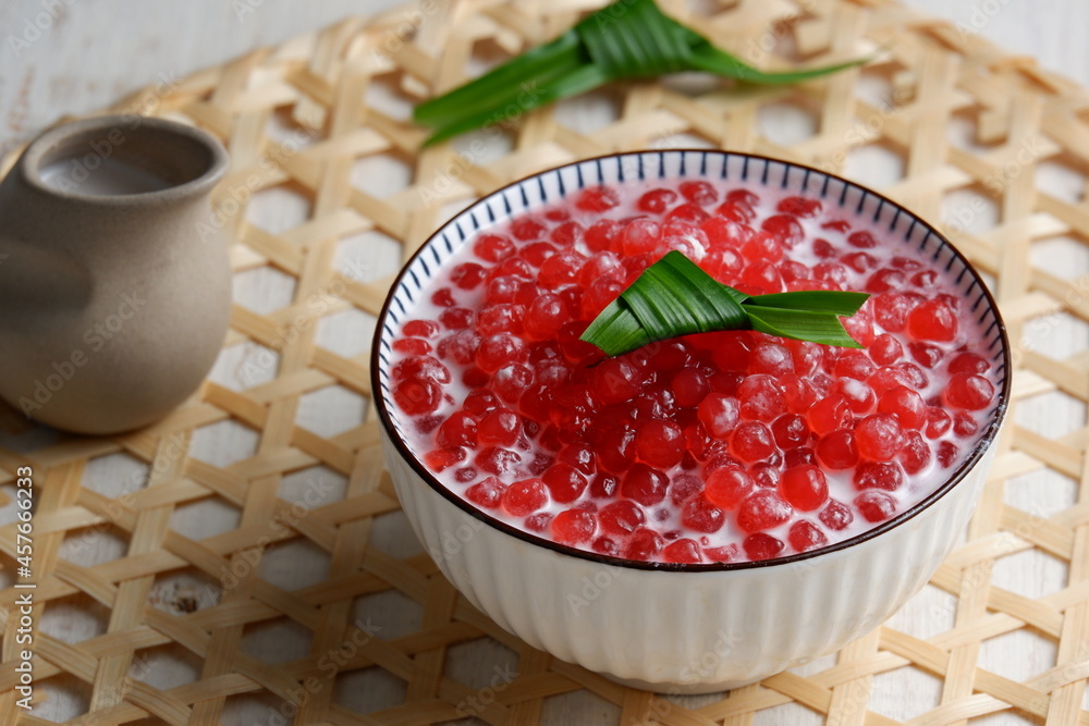 Bubur Mutiara or Sago pearls porridge,Indonesian popular traditional dessert made from sago pearls and coconut milk, served on ceramic bowl,with pandan leaves.