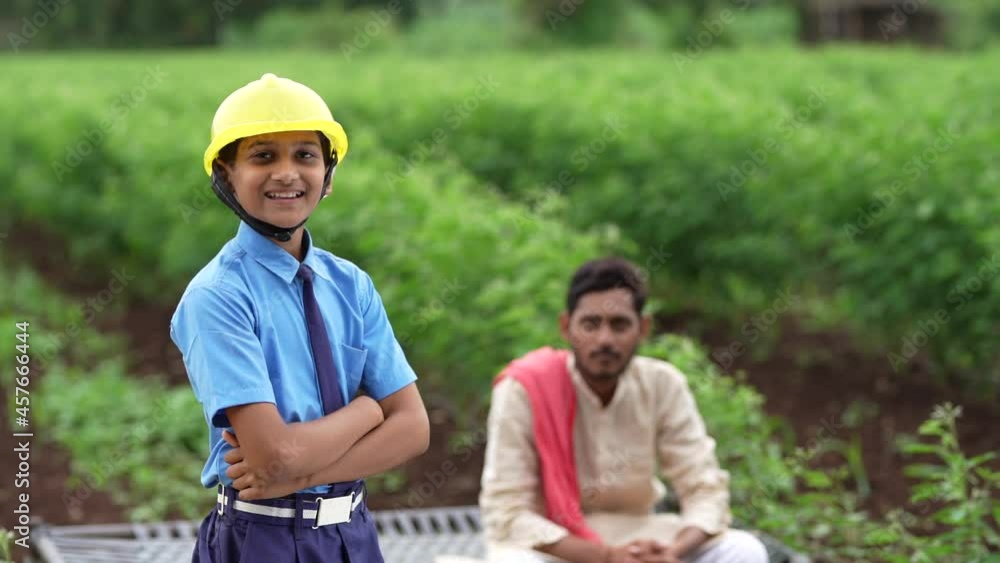 Cute Asian Indian little child wearing yellow construction helmet or safety hard hat. Cute Asian Indian little child wearing yellow construction helmet or safety hard hat.