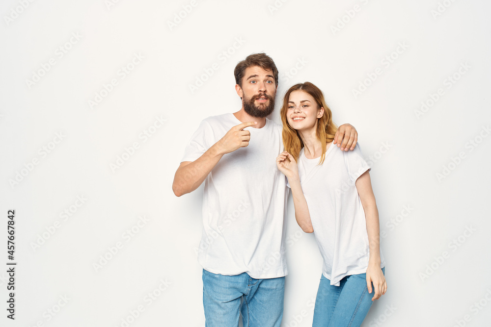 cheerful young couple in white t-shirts embrace friendship lifestyle cheerful young couple in white t-shirts embrace friendship lifestyle