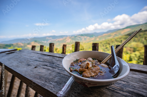 Close up thai noodle with beautiful landscape view of doi skad at nan thailand.Nan is a rural province in northern Thailand bordering Laos photo