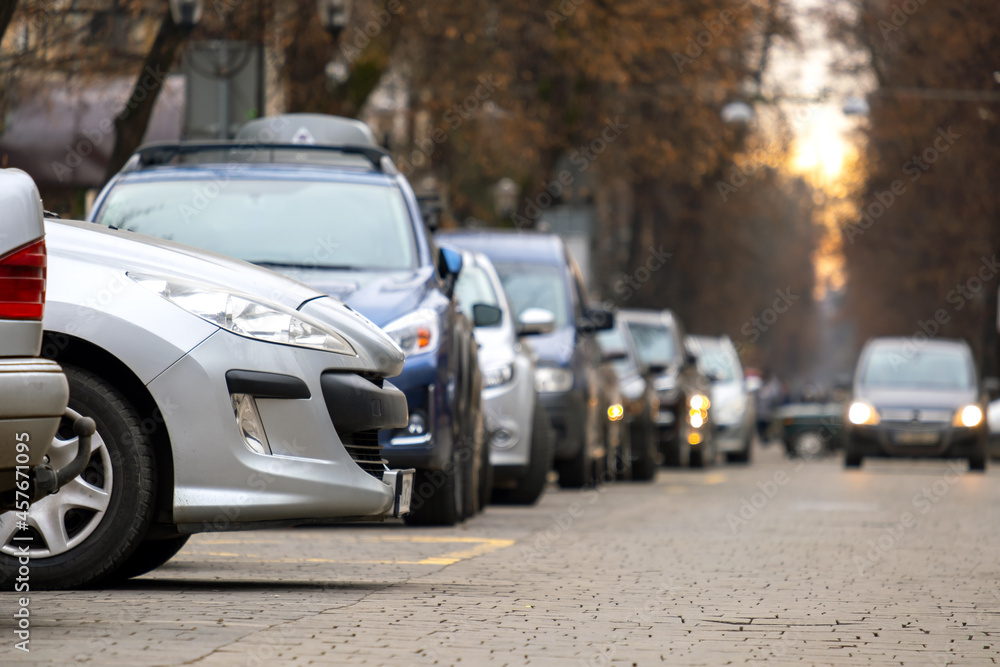 Cars parked in a row on a city street side.