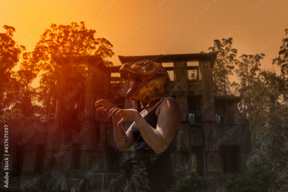Woman in dinosaur mask gesturing with hands terror halloween concept - obrazy, fototapety, plakaty 