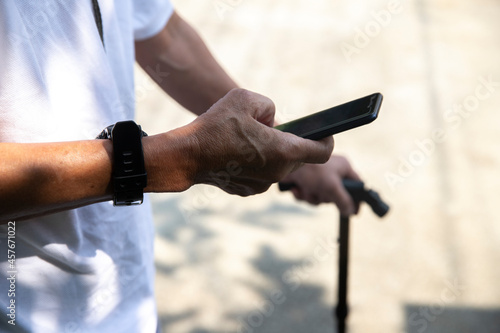 Close up view of eldery man hands using smart phone © aumnat