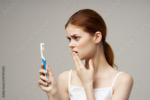 cheerful woman with a toothbrush in hand morning hygiene isolated background