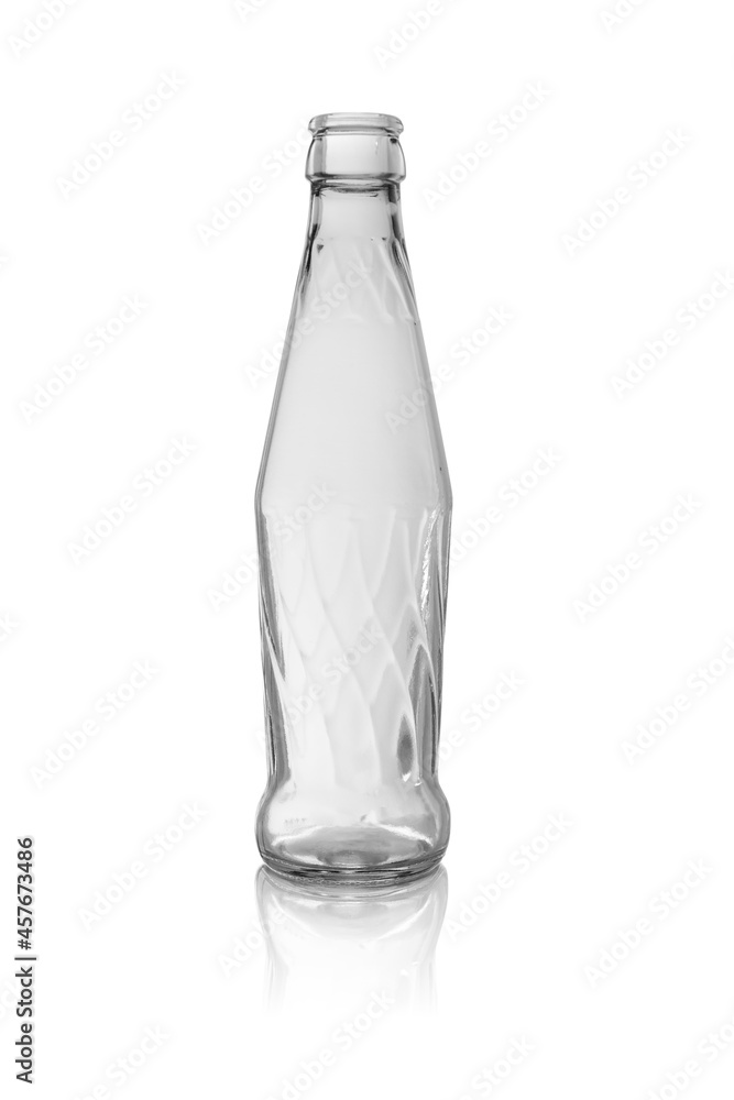 Empty glass bottle with a pattern, transparent without a lid. Isolated on a white background, with reflection. Empty glass bottle with a pattern, transparent without a lid. Isolated on a white background, with reflection.