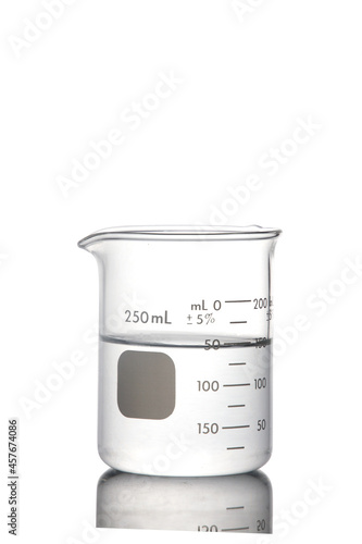 Laboratory equipment, beaker filled by coloress liquid with reflection isolated on white background with clipping path.