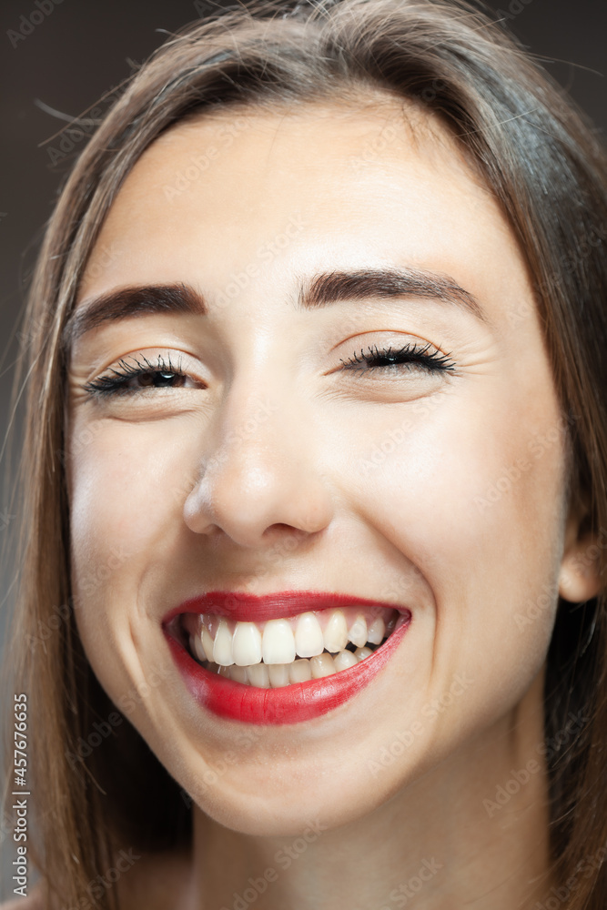 Beautiful brunette girl studio portrait. Smiling face expression. Beautiful brunette girl studio portrait. Smiling face expression.