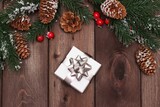 new year or christmas gift on a wooden background.  tree branches