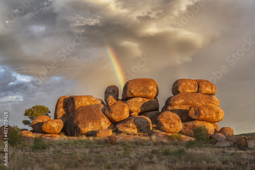 Devil's Marbles in Northern Territory and a rainbow on the background photo