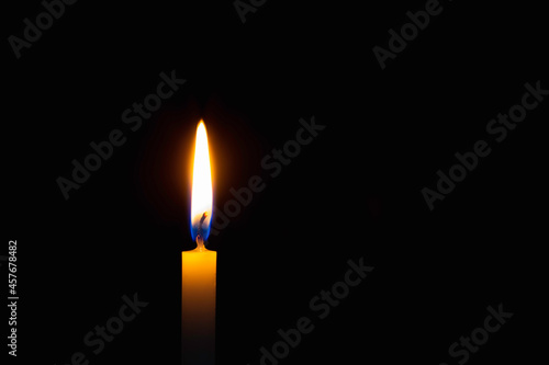 Light candle flame blurred background. Light candle a on black background.