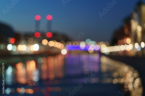Defocused photography of Moscow cityscape in night. City in bright light. Heat station smoking pipes. Blue sky. Chimneys. Concept of beauty of capital of Russian Federation. Free space for message