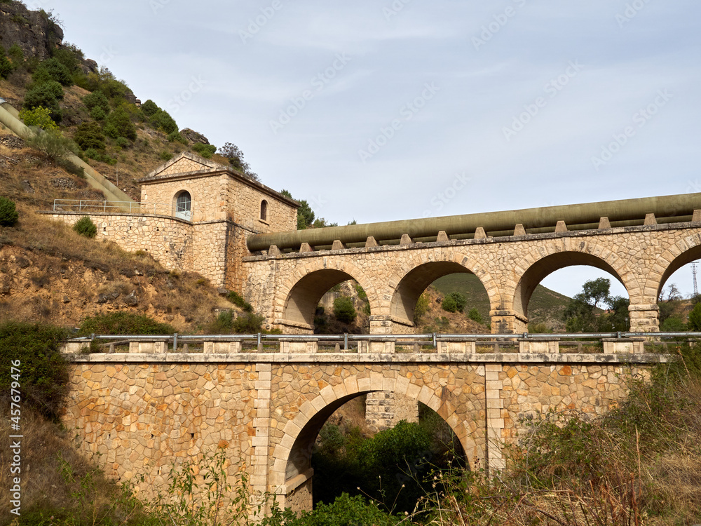 Photography of Canal de Isabel II aqueduct at the entrance of Patones de Arriba, a charming village in the mountains of Madrid. Spain, Europe