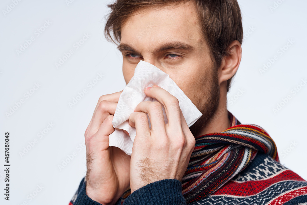 emotional man with a handkerchief health problem flu symptoms isolated background emotional man with a handkerchief health problem flu symptoms isolated background