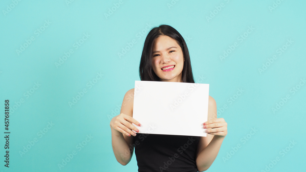 Blank empty paper in asian woman's hand on mint green or Tiffany Blue background. Blank empty paper in asian woman's hand on mint green or Tiffany Blue background.