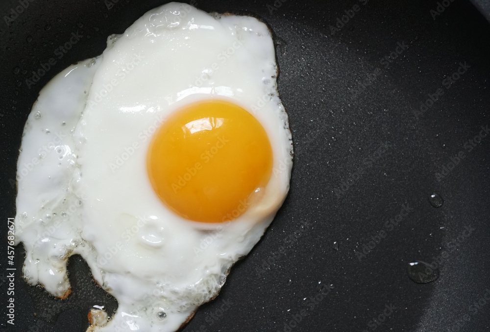 Fried egg in a frying pan, Close up, Top view Fried egg in a frying pan, Close up, Top view