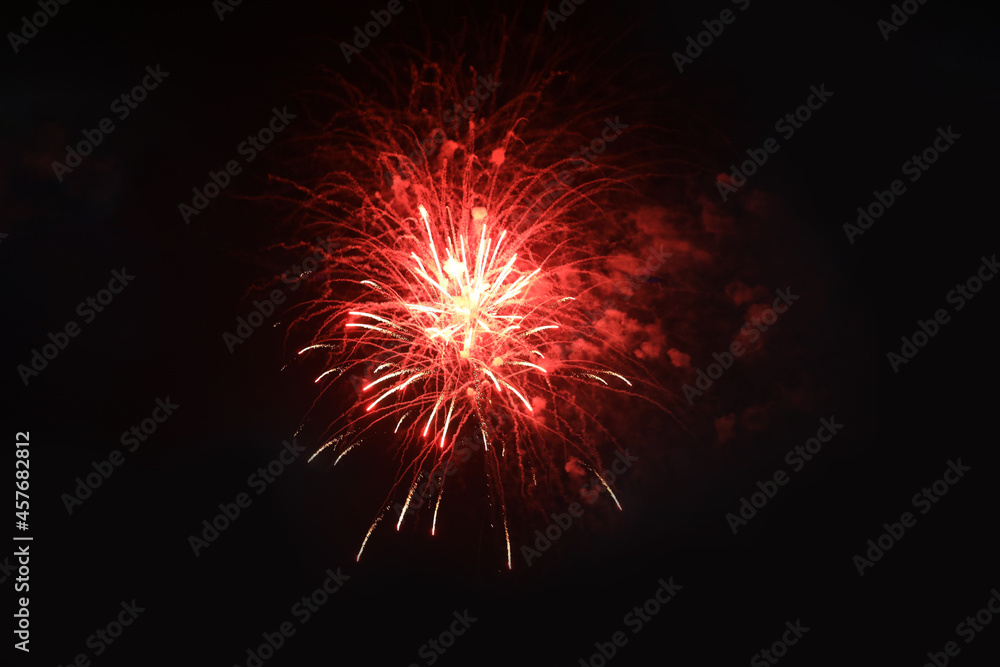 People watching beautiful bright fireworks outdoors at night People watching beautiful bright fireworks outdoors at night